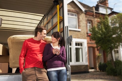 Removal professionals handling bulky items in a flat